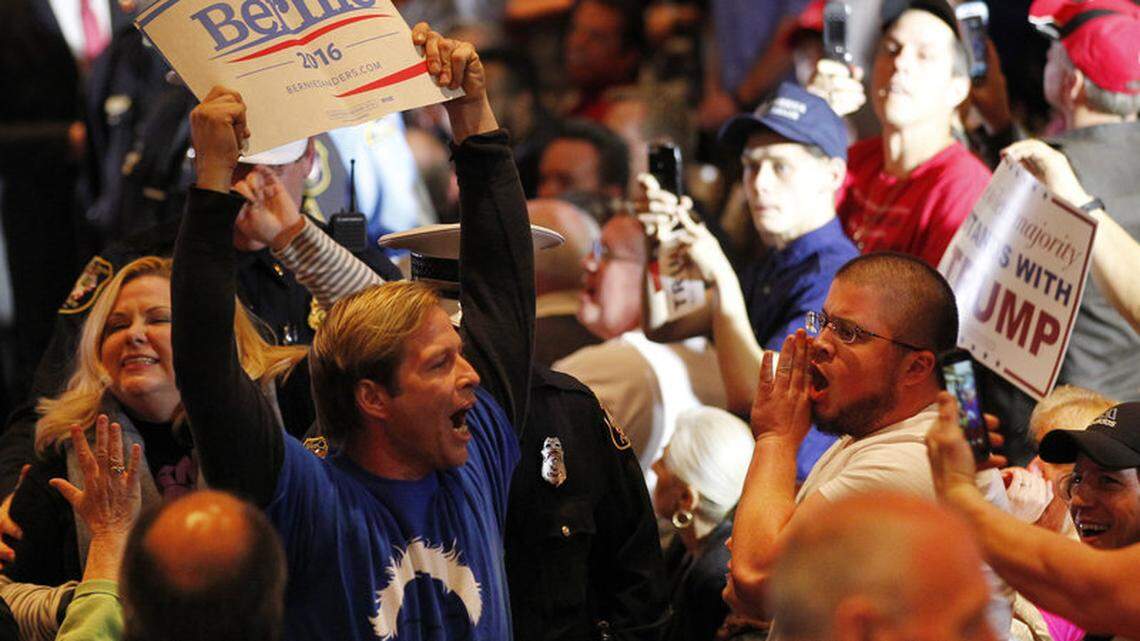 A Bernie Sanders supporter is taken out by police from a Donald Trump rally in 2016 in Cincinnati.