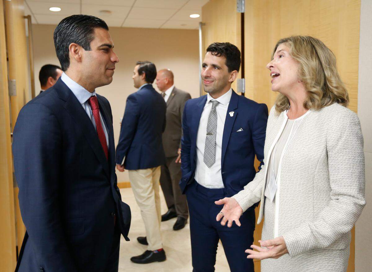 Mayor of Miami Francis Suarez, left, speaks to Program Manager Jorge Damian de la Paz and Assistant Provost Dr. Robin Bachin at the launch of the University of Miami’s LAND tool at the Miami-Dade Beacon Council on Wednesday.
