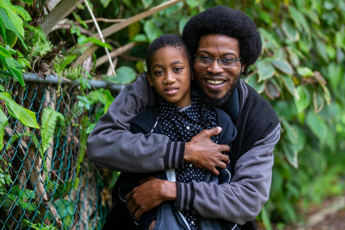 Jerry Rateau, 37, and his son, Jeremiah Rateau, 7, spend time together at Jeremiah’s grandmother’s house near North Miami Beach on Wednesday. Jerry  has been having difficult conversations with his son since the child watched the video of George Floyd losing consciousness under the pressure of Derek Chauvin’s knee.