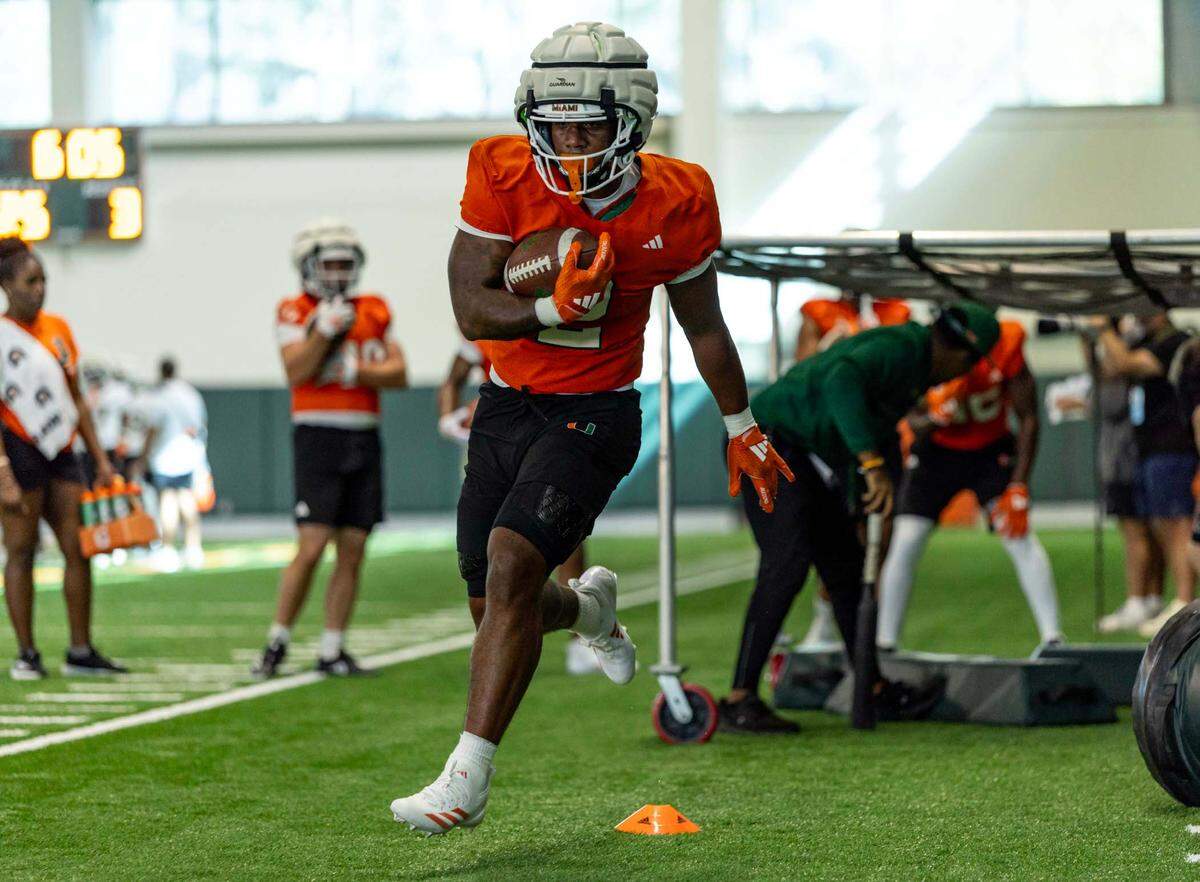 Miami Hurricanes running back Jordan Lyle (2) carries the ball as he runs through a drill during spring practice at the Carol Soffer Indoor Practice Facility at the University of Miami on Wednesday, March 5, 2025, in Coral Gables, Florida. 
