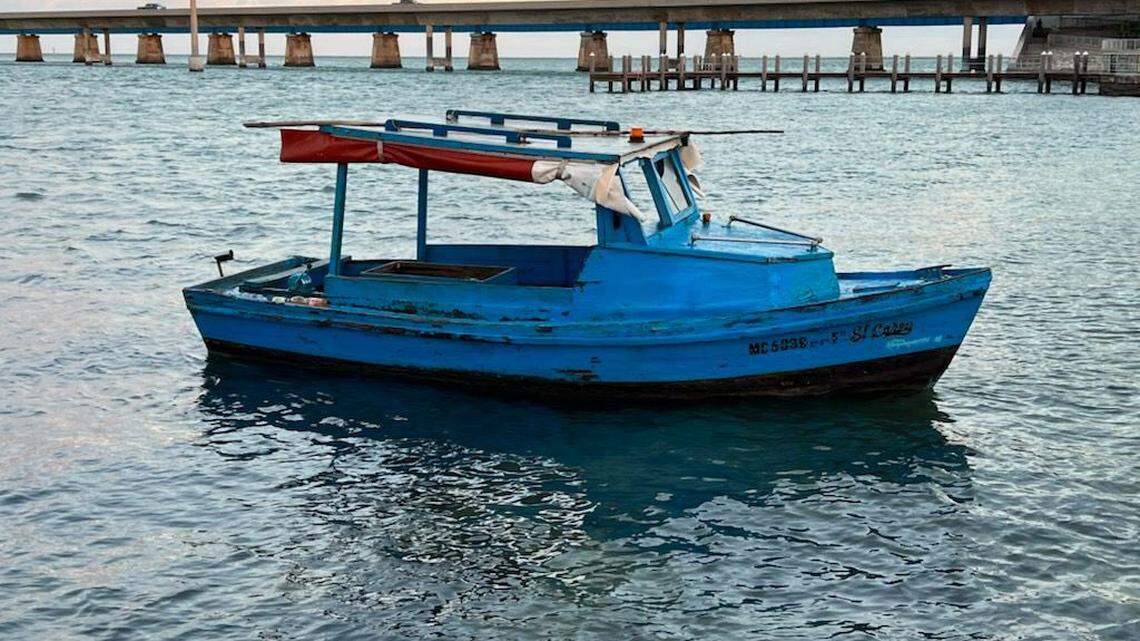A wooden fishing boat floats in the water close to shore near the southern base of the Seven Mile Bridge in the Middle Florida Keys city of Marathon Tuesday, March 1, 2022. Another boat arrived in almost the same location Wednesday, March 30, 2022.