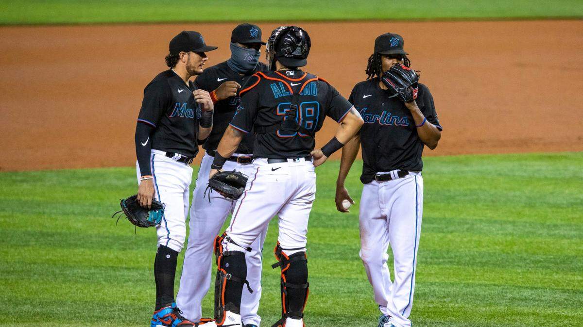Miami Marlins right-handed pitcher Jose Urena (62) is visted at the mound by the Marlins infielders and catcher before allowing Philadelphia Phillies infielder Didi Gregorius (18) to score a grand slam during the first inning of a Major League Baseball game against the Phillies at Marlins Park in Miami, Florida on Saturday, September 12, 2020.