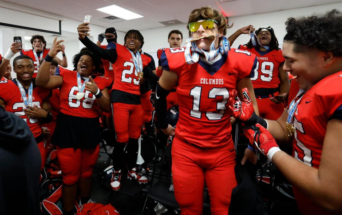Columbus Explorers JJ Gomez (13) joins the team as they celebrate in the locker room after defeating Mandarin Mustangs in the FHSAA State Championships, Class 4M, at Bragg Memorial Stadium in Tallahassee, Florida, on Friday, December 8, 2023.