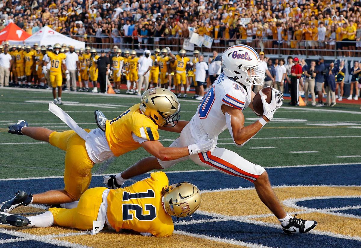 St. Thomas Aquinas defensive backs Maximus Mustell (1) and Justice Fitzpatrick (12) attempt to stop Las Vegas Bishop Gorman wide receiver Derek Meadows from scoring a touchdown during football game on Saturday, August 24, 2024 at St. Thomas Aquinas HS in Fort Lauderdale. Andrew Uloza / for Miami Herald