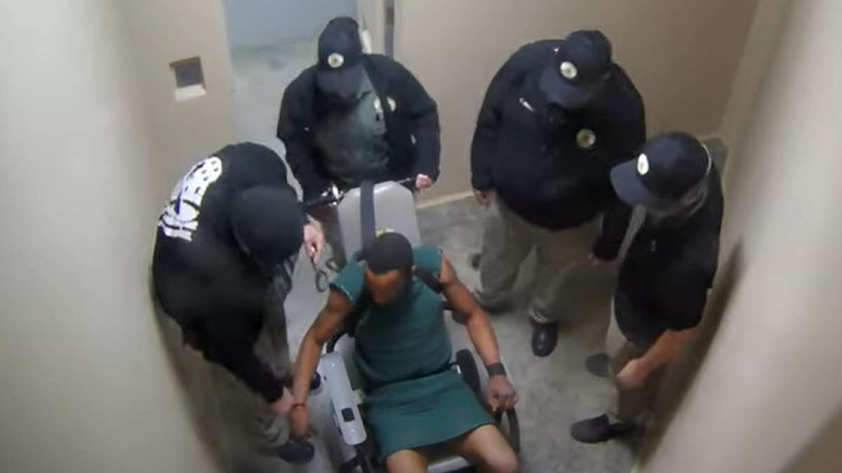 A Georgia corrections officer strangled a pretrial detainee in solitary confinement and other officers watched, according to a federal lawsuit.