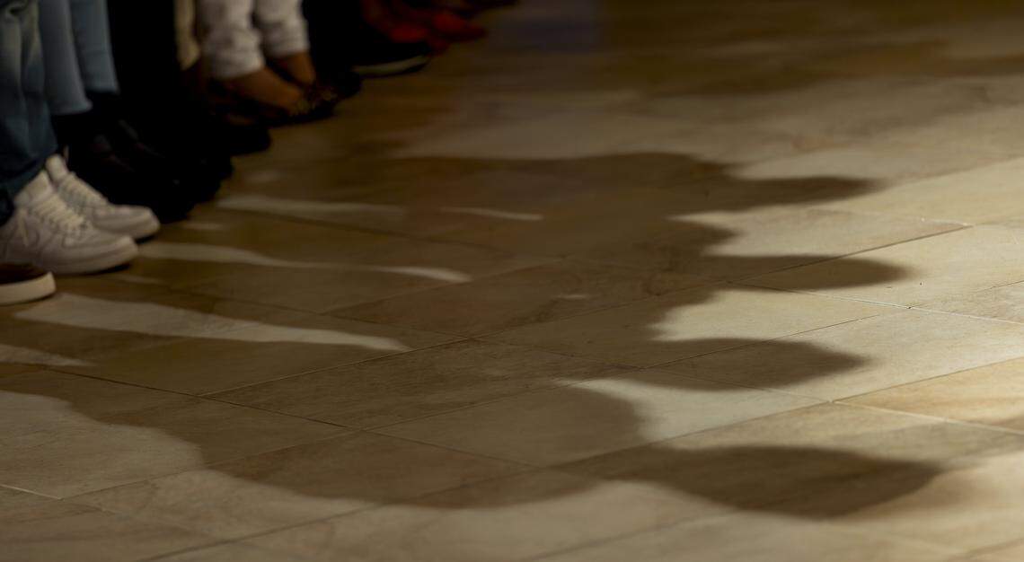 People pray as they listen to a pastor speak during a vigil at Christ Lutheran Church on Saturday, Aug. 9, 2025, in Oakland Park, Fla. The vigil brought together immigrant families and others supporting loved ones in migrant detention centers, such as Alligator Alcatraz, across the state and country.