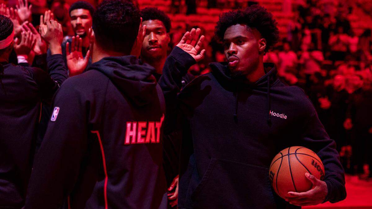 Miami Heat guard Davion Mitchell (45) interacts with teammates before the start of the first half of an preseason NBA game against the Milwaukee Bucks at Kaseya Center on October 6, 2025, in Miami.