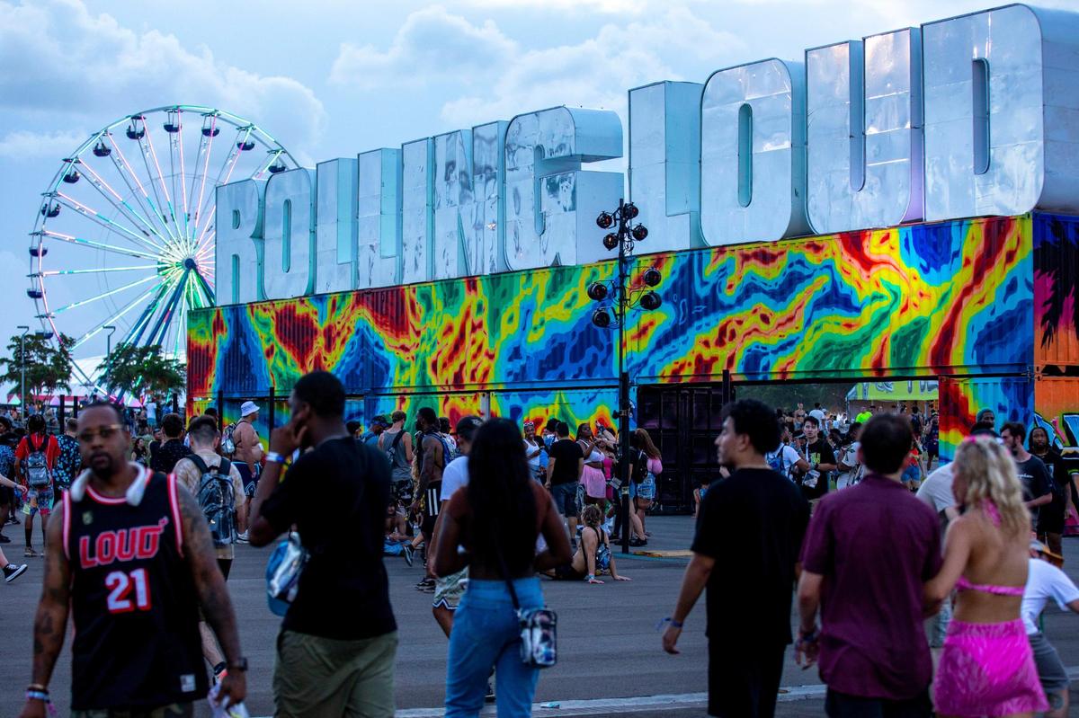 Festival goers walk the grounds during the first day of Rolling Loud Miami, an international hip-hop festival, at Hard Rock Stadium in Miami Gardens, Florida, on Friday, July 22, 2022.