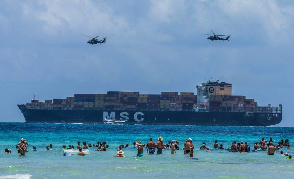 A pair of helicopters from the 8-229th Assault Helicopter Battalion fly over a cargo ship departing PortMiami during a demonstration over South Beach as part of the Hyundai Air & Sea Show, held Saturday, May 24, 2025, during Miami Beach’s annual National Salute to America’s Heroes.