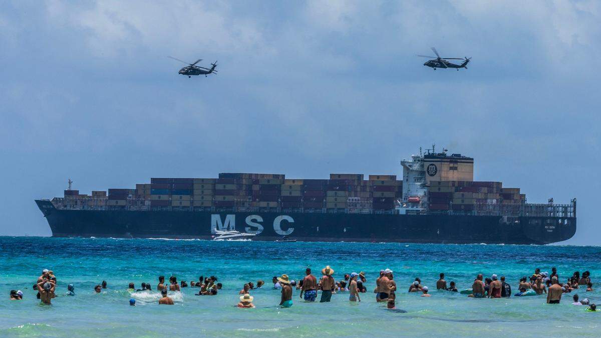 A pair of helicopters from the 8-229th Assault Helicopter Battalion fly over a cargo ship departing PortMiami during a demonstration over South Beach as part of the Hyundai Air & Sea Show, held Saturday, May 24, 2025, during Miami Beach’s annual National Salute to America’s Heroes.