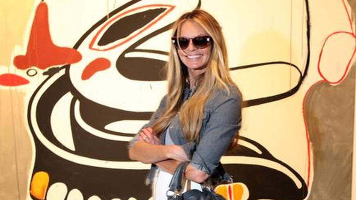 
Supermodel, Elle Macpherson, at Art Basel at the Miami Beach Convention Center, Wednesday, Dec. 3, 2014. Elle was wearing a jacket by Marques Almeida, a top by Velvet, a skirt by Sea, shoes by Sophia Webster, sunglasses by Fendi and a bag by Christian Louboutin.
