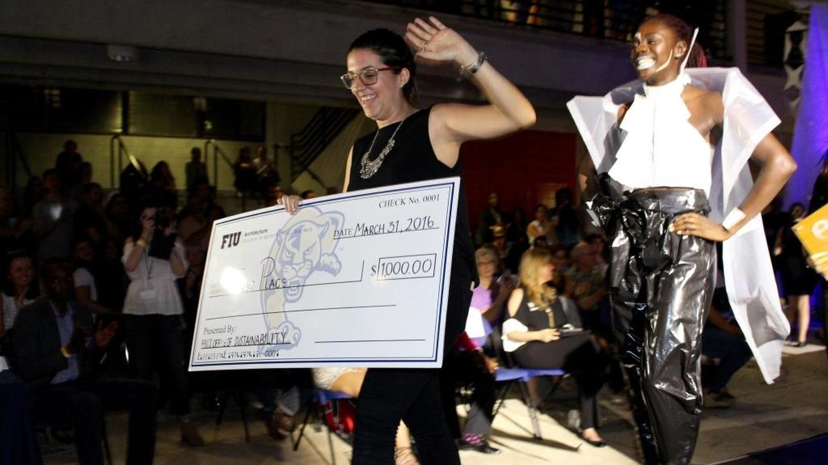 First place winner Laura De La Vega struts down the runway with model Danyealah Green-Lemons at the third annual Eco Couture Recycling Fashion Show at FIU's School of Architecture on March 31.