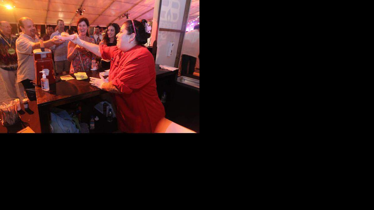 
Burger, please: Chef Mercedes Gonzales of El Rey De Las Fritas hands out food at the Burger Bash at the 2014 South Beach Wine & Food Festival. 
