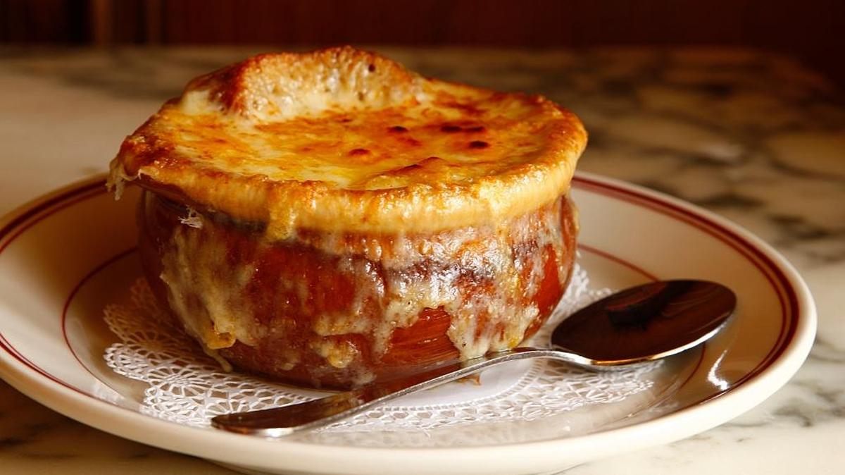 A crock of classic French onion soup is $13 at Stephen Starr’s Le Zoo in Bal Harbour.