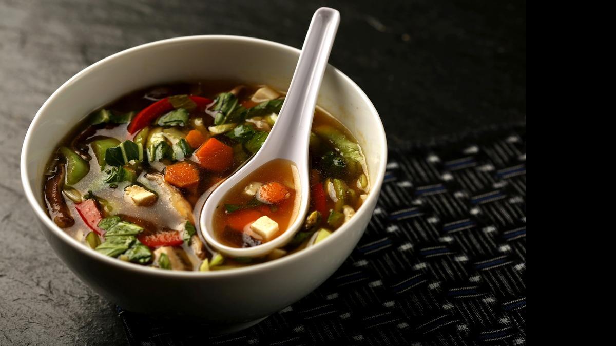 
Broth simmers with mushroom stems and fresh ginger to develop flavor. After that, chopped carrots, bok choy, red pepper, mushrooms and tofu go in for a colorful, flavorful dinner. 
