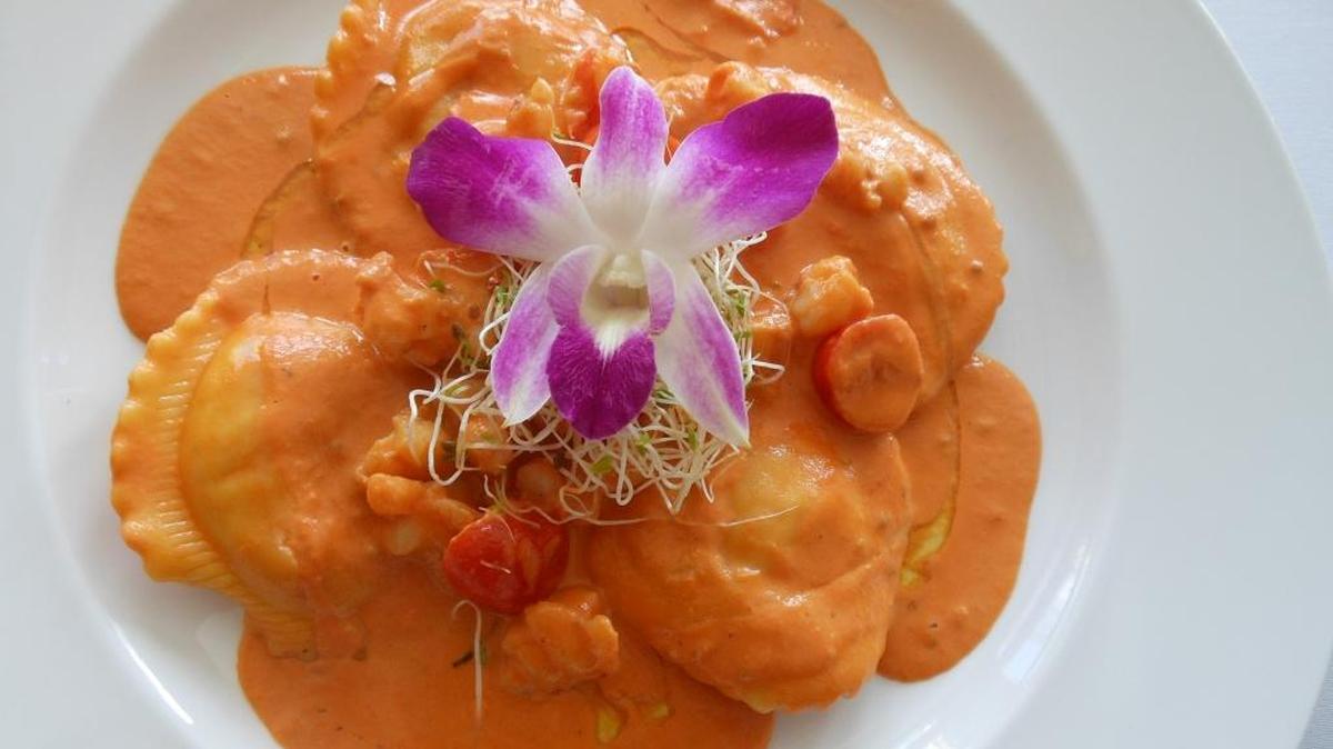 Housemade lobster ravioli with diced shrimp in creamy pink vodka sauce at Limoncello Italian Restaurant in Aventura.