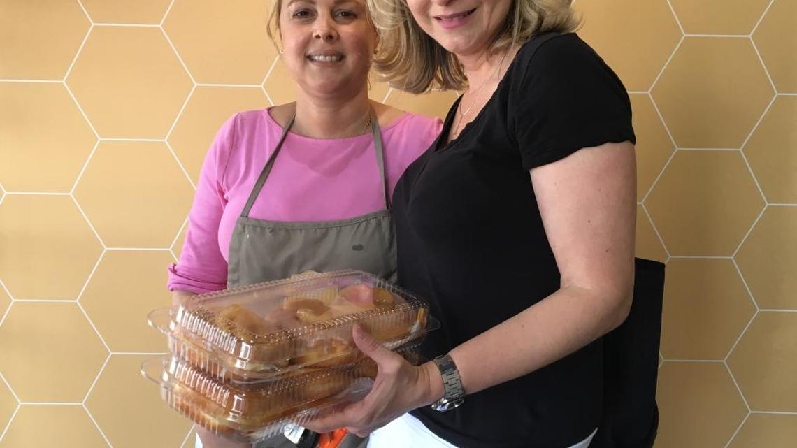 Honeybee Doughnuts shop owner Karen Muirhead, left, and Day One fan Jeannette Vidal during National Donut Day on Friday June 3rd, 2016.