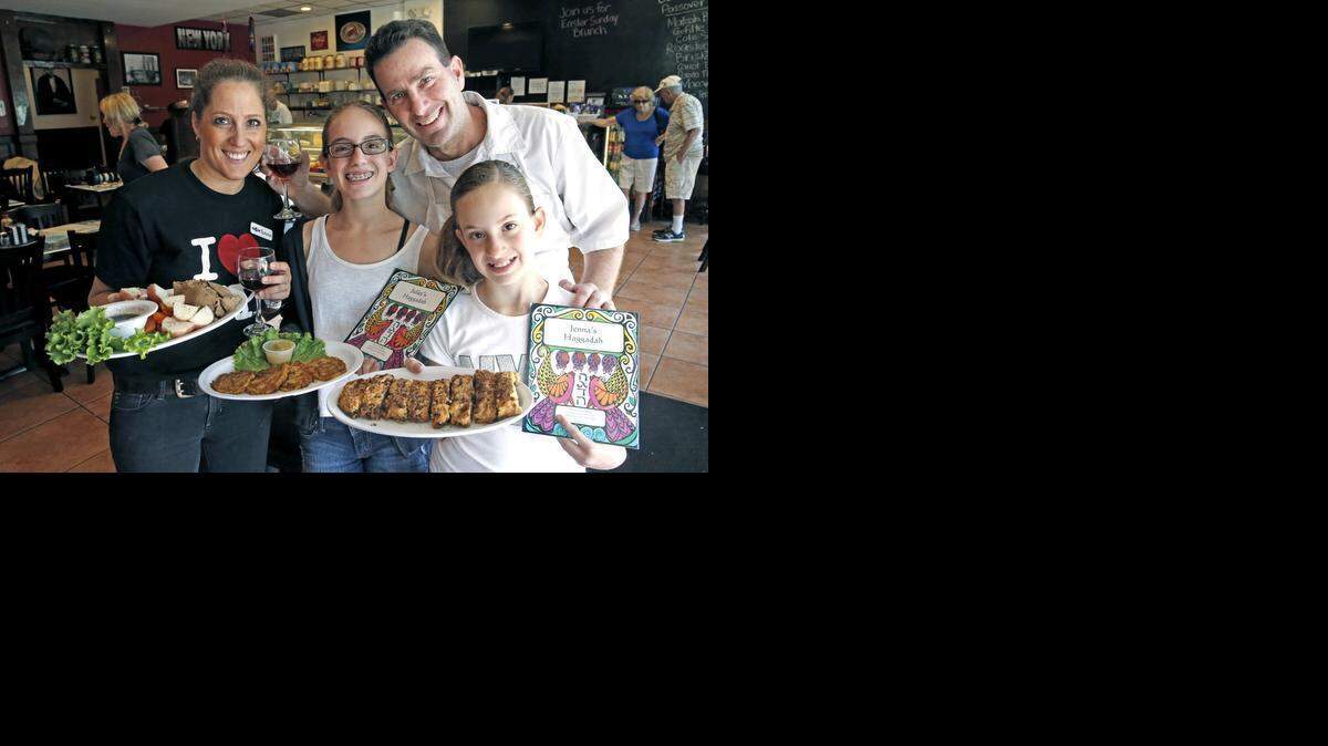 
New tradition: Tammie Weiss-Bell and her husband, Gary Bell, with their daughters Juliet, 11, center, and Jenna, 10, will host a Seder for customers on Saturday at their NY Deli. 
