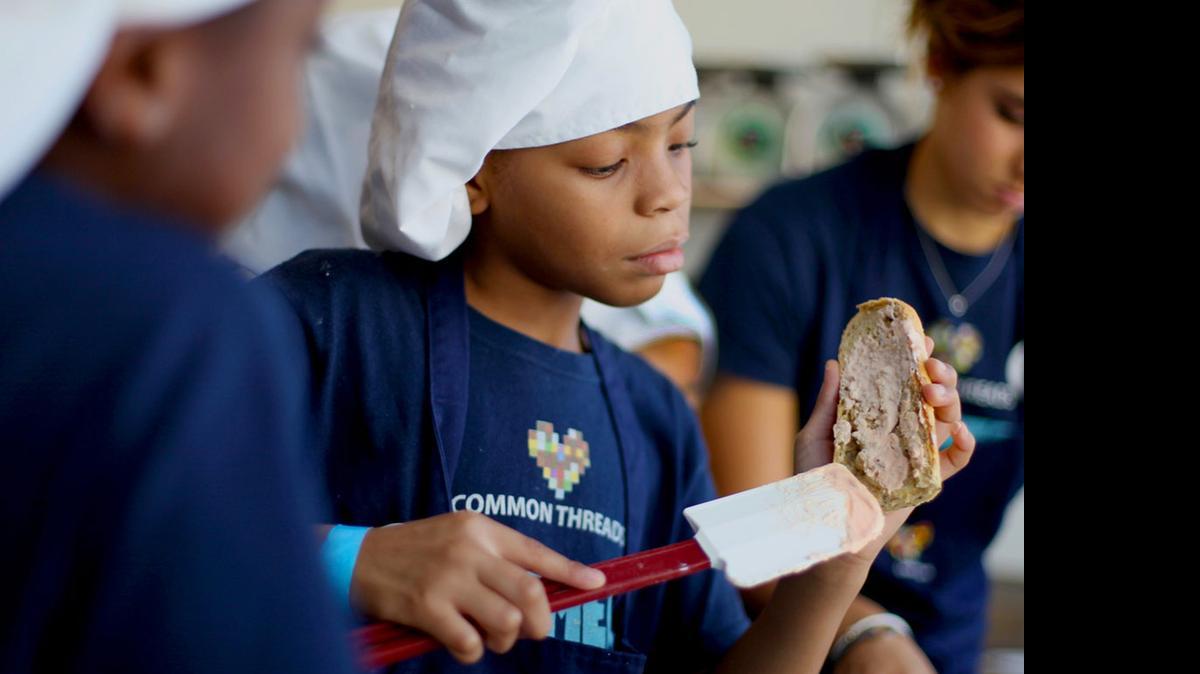 
Like a pro: A student works on a dish as part of a Common Threads program. The group’s Miami efforts have received a $10,000 grant from The Miami Foundation. 

