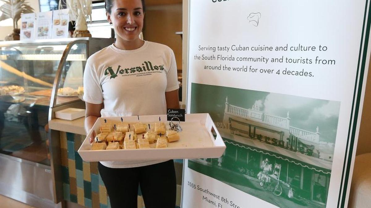 
Fresh football food: Nicole Valls of Versailles presents a tray of Cuban sandwiches like the ones that Versailles will sell at Miami Dolphins home games this year at Sun Life Stadium in Miami Gardens. 
