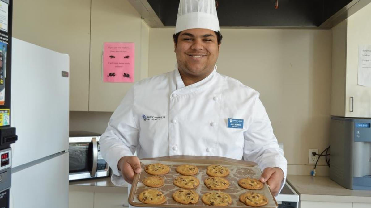 James Shannon, 19, displays his latest batch of chocolate chip cookies in his Johnson & Wales dormitory's kitchen.