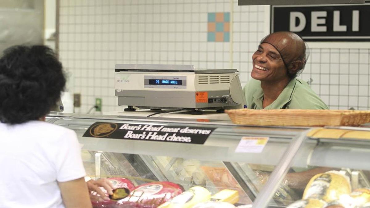 A deli clerk at the Publix in Coral Gables serves a customer in August 2012.