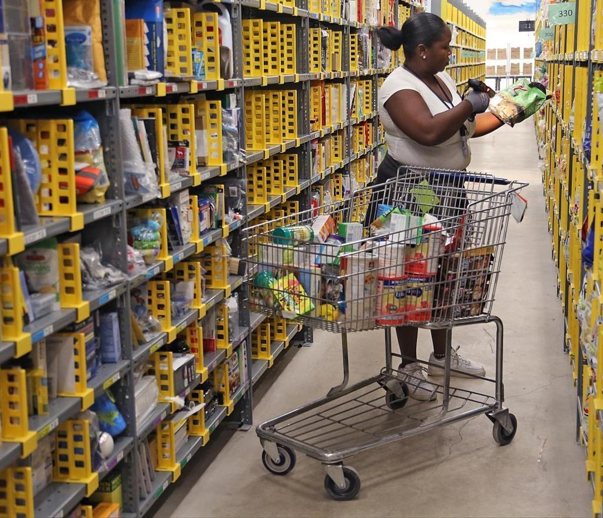 Employee Natasha Brown stocks items using the “random stow” system develop for the new Amazon Prime Now Miami hub in Wynwood. Employees stocked, prepared, and trained on protocols on Tuesday, June 27 as the new Amazon Prime Now Miami hub in Wynwood geared up for its grand opening the next day.