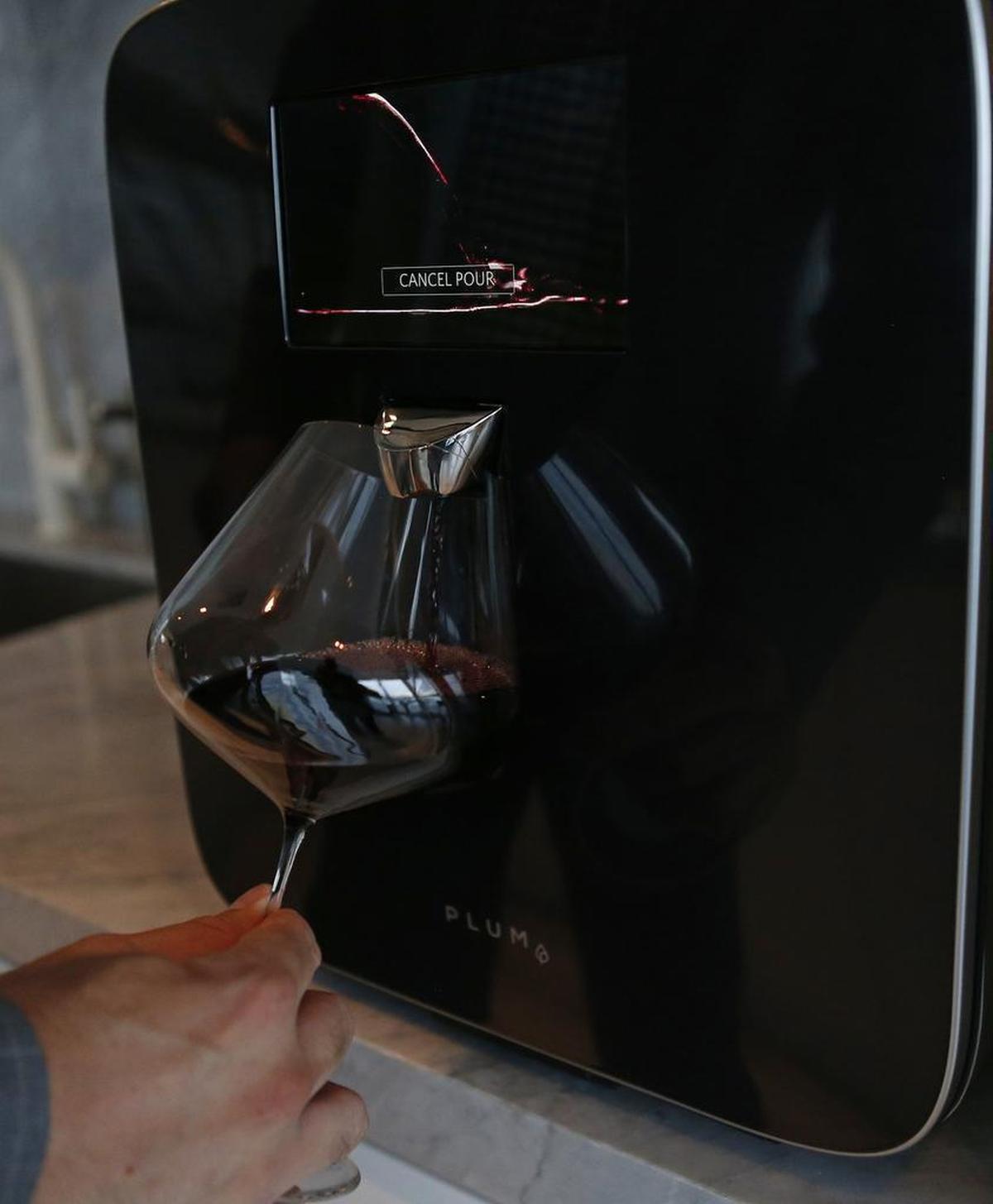 David Koretz, CEO of Plum, right, uses the Plum at his Miami home, above. Koretz created the high-tech wine appliance that serves wine at the perfect temperature and can preserve it for up to 90 days. Plum has 18 signed hotel deals so far.