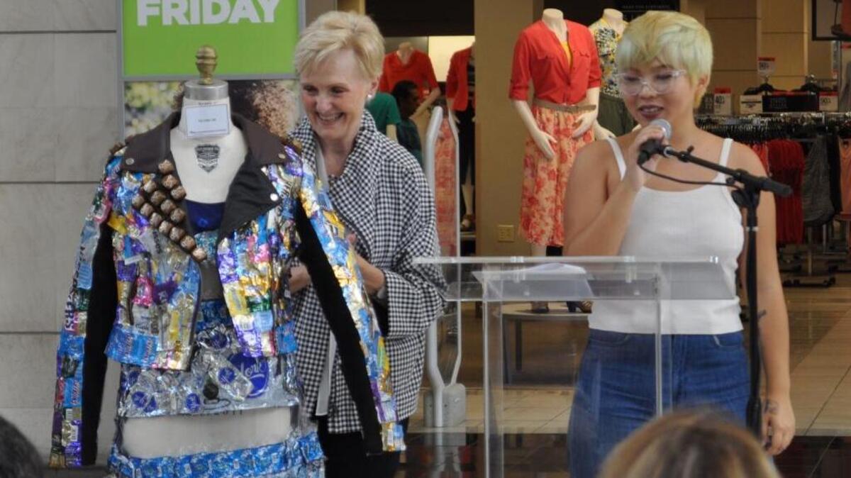 Charlene Parsons, director of Miami International University of Art & Design admires a candy-covered dress by student Yu Chu Liu at the second annual Chocolate Show April 29, 2017, at Miami International Mall in Doral.