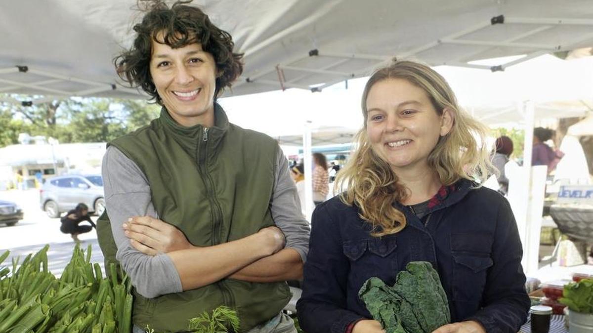 Muriel Olivares, left, and Tiffany Noé of Little River Cooperative. They sell produce from their urban farm and nursery at the Upper Eastside Farmers Market at Legion Park in Miami.