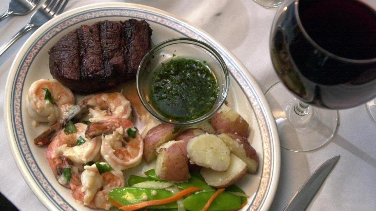 Red zinfandel is the best choice to taste delicious with both a steak and seafood, shown here.