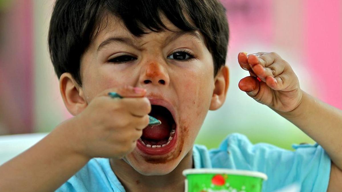Santiago Carballo, 2, enjoys his chocolate gelato at Fairchild Tropical Botanic Garden’s 11th Annual International Chocolate Festival on Sunday, Jan. 22, 2017.