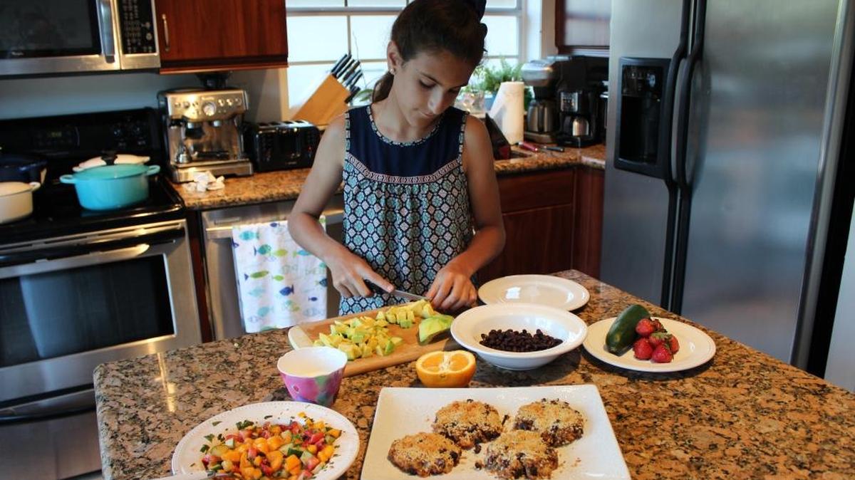 Chef Olivia LaRochelle prepares a dish in her Kendall home.