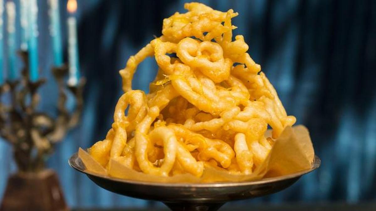 Iraqi funnel cake is fried then topped with a lemon syrup.