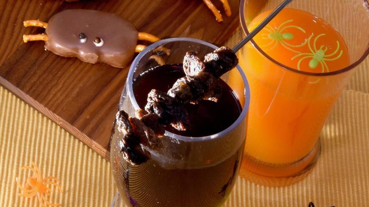 Halloween cocktails can be served alongside salty-and-sweet Reese’s Spiders, made with peanut butter, chocolate and pretzels.