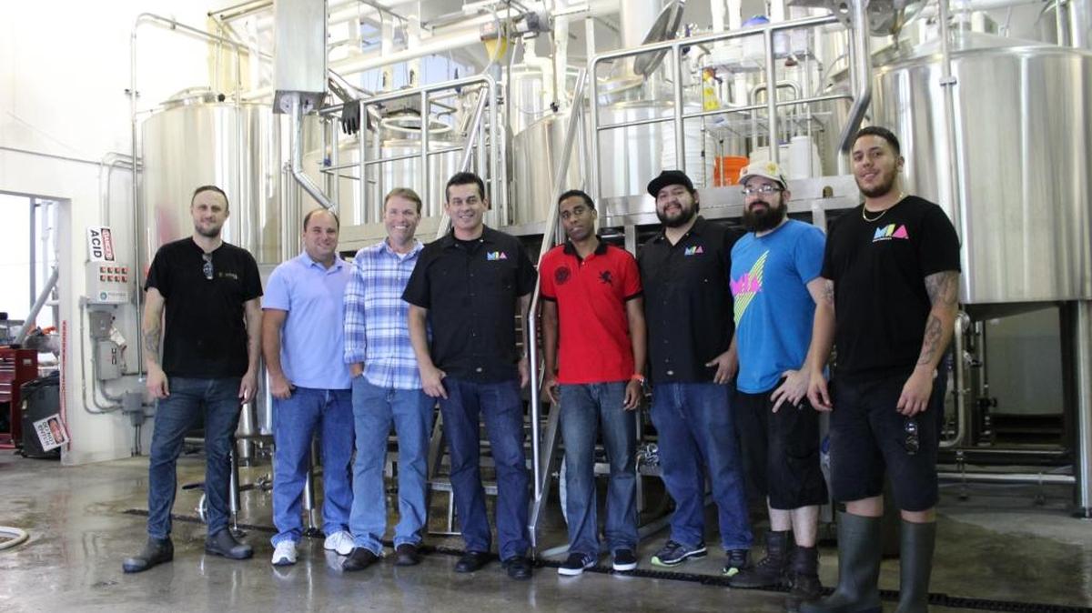 The M.I.A. Beer Company family: From left, Michael Demetrus, Howard Holschauer, Kevin Smith, Eddie Leon, Johann Beckford, Claudio Menicocci, Orestes ‘Rusty’ Hernandez and Chris Lacerna.