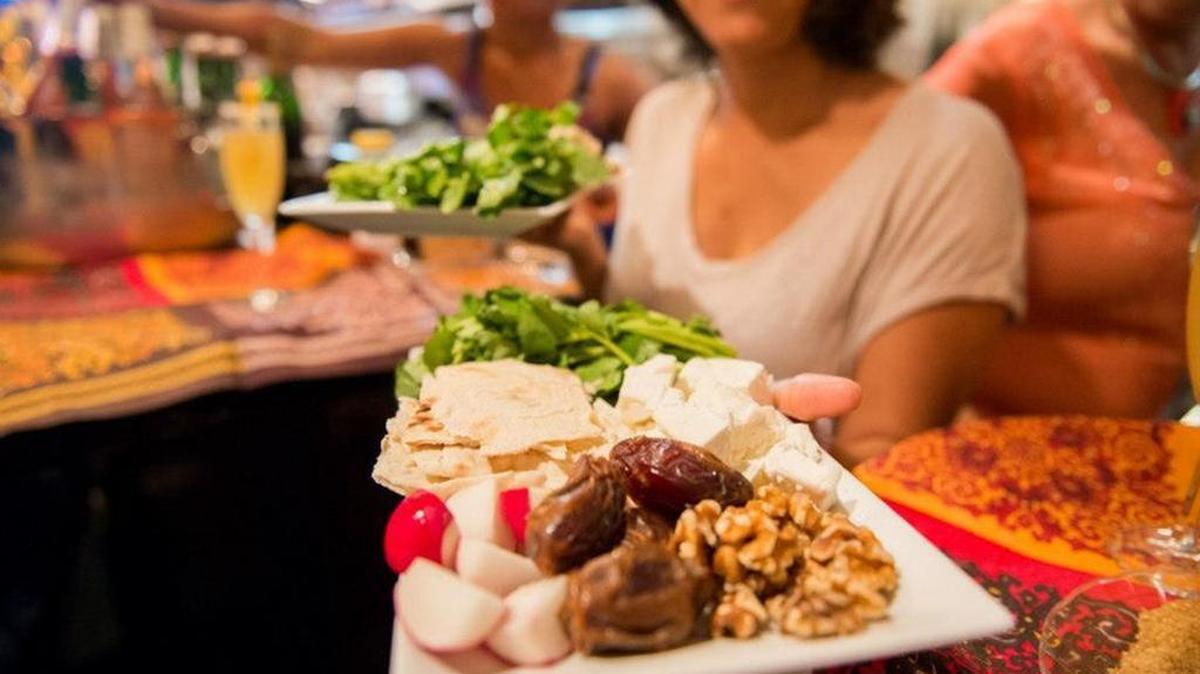 
A Saffron Supper Club host holds a plate of food from one of the group’s Persian-inspired meals. 
