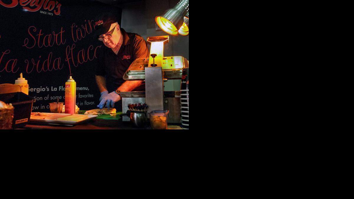 
Dagoberto Bustos of Sergio's Restaurant prepares a Cuban sandwich during a competition to find South Florida's best Cuban sandwich. Sergio’s will now represent Miami at the Tampa Cuban Sandwich Festival.
