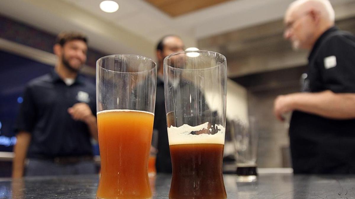From left, Juan Tamayo, Master’s candidate in Hospitality, Albert Rivera, undergrad in Hospitality and Professor Barry Gump, Ph.D., chair of beverage management for Florida International University's Chaplin School of Hospitality & Tourism Management, try and test different beers as they talk about the fifth annual North Miami Brewfest, celebrating Florida brewers and the growing popularity of the craft beer industry hosted by the school Saturday, Nov. 19.