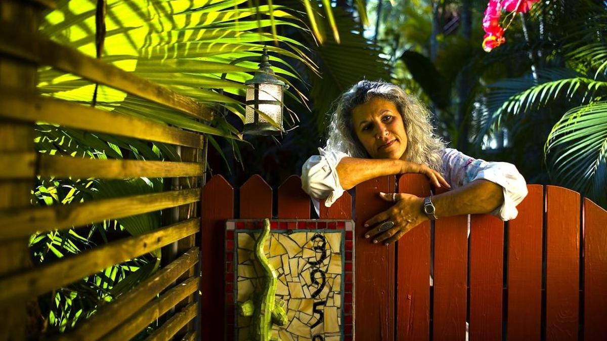 Lisa Remeny is seen at her Coconut Grove studio, where the Miami Beach-born artist and painter works on her hallmark hyper-realistic images of nature. This week, she’s finishing a painting to raise money for the Bali Ha’i event Sunday at The Kampong, David Fairchild’s former winter home.
