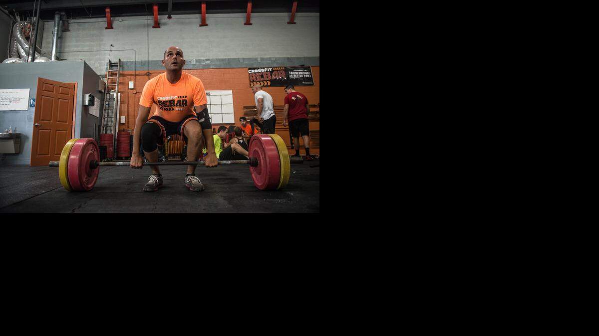 Rigoberto Abraham, who suffered a heart attack 2 years ago, uses crossfit as physical theraphy at Crossfit Rebar on Friday, Sept. 19 ,2014 in Kendall, Fla.