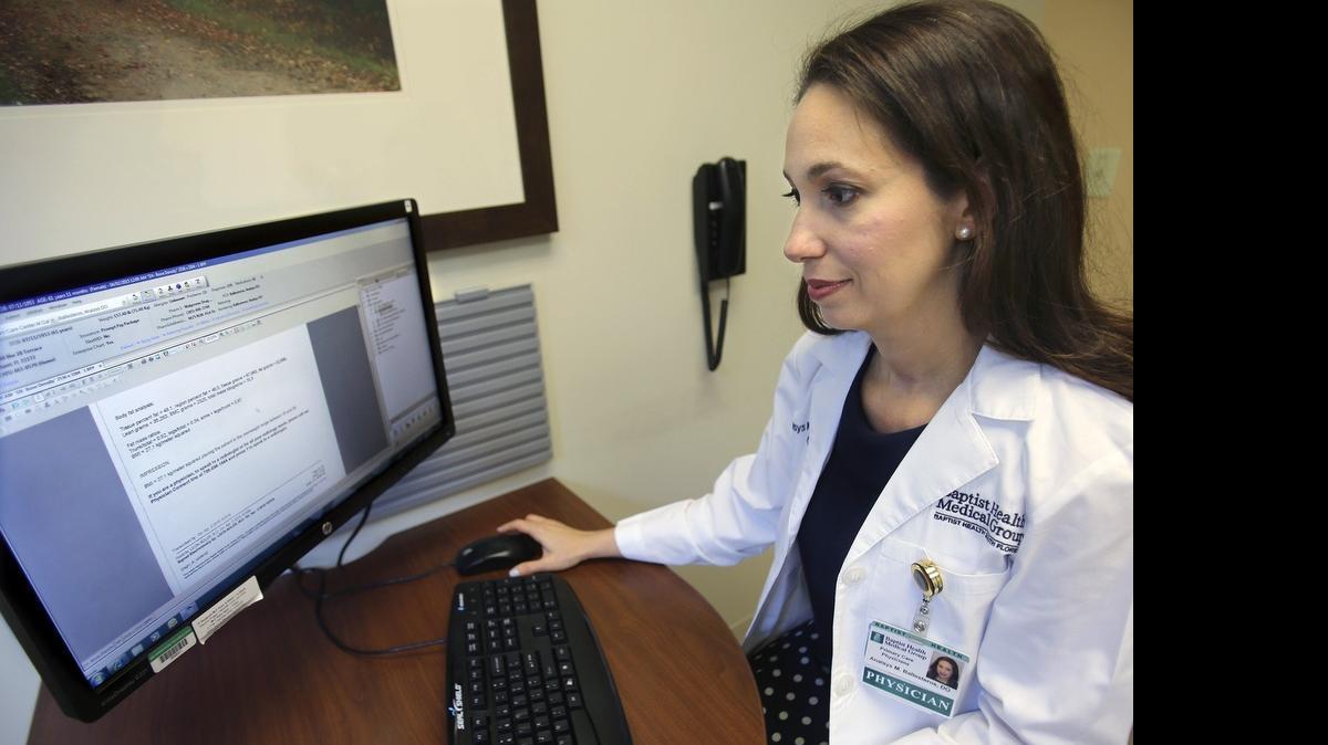 FINDING THE FAT:  Dr. Anaisys Ballesteros, D.O., a Baptist Health Primary Care physician, reviews the results of a patient's DEXA Body Fat Scan. DEXA scans can pinpoint where the body stores fat.