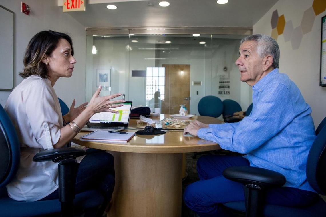 Ricardo Casas explains to his mentee Mayala Lanza the processes in business negotiation at the SCORE offices in Coral Gables.