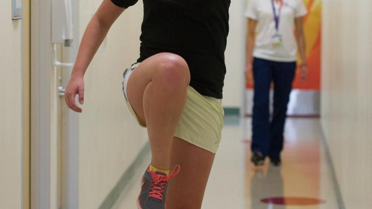 
Carly Duncan, 17, a member of the Miami Premier Soccer Club, exercises as part of her physical therapy for an ankle injury. Lauren Butler, a doctor of physical therapy at Nicklaus Children's Hospital, directs her on Sept. 10, 2015, in the Sports Medicine Department at the Nicklaus Children's Hospital West Kendall Outpatient Center.
