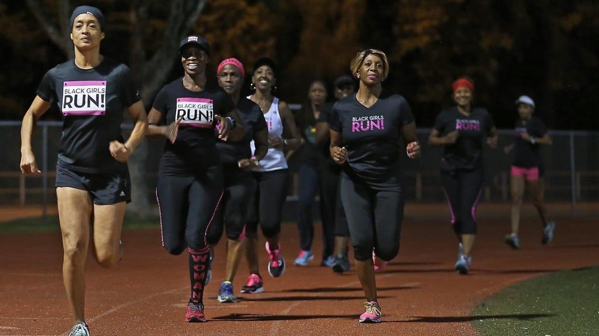 Sandra Lee (left) leads a group, from the Miami Chapter of Black Girls RUN!, as they train for the Miami Marathon and Half Marathon at the track at Alonzo and Tracy Mourning Senior High School on Wednesday, January 18, 2017.