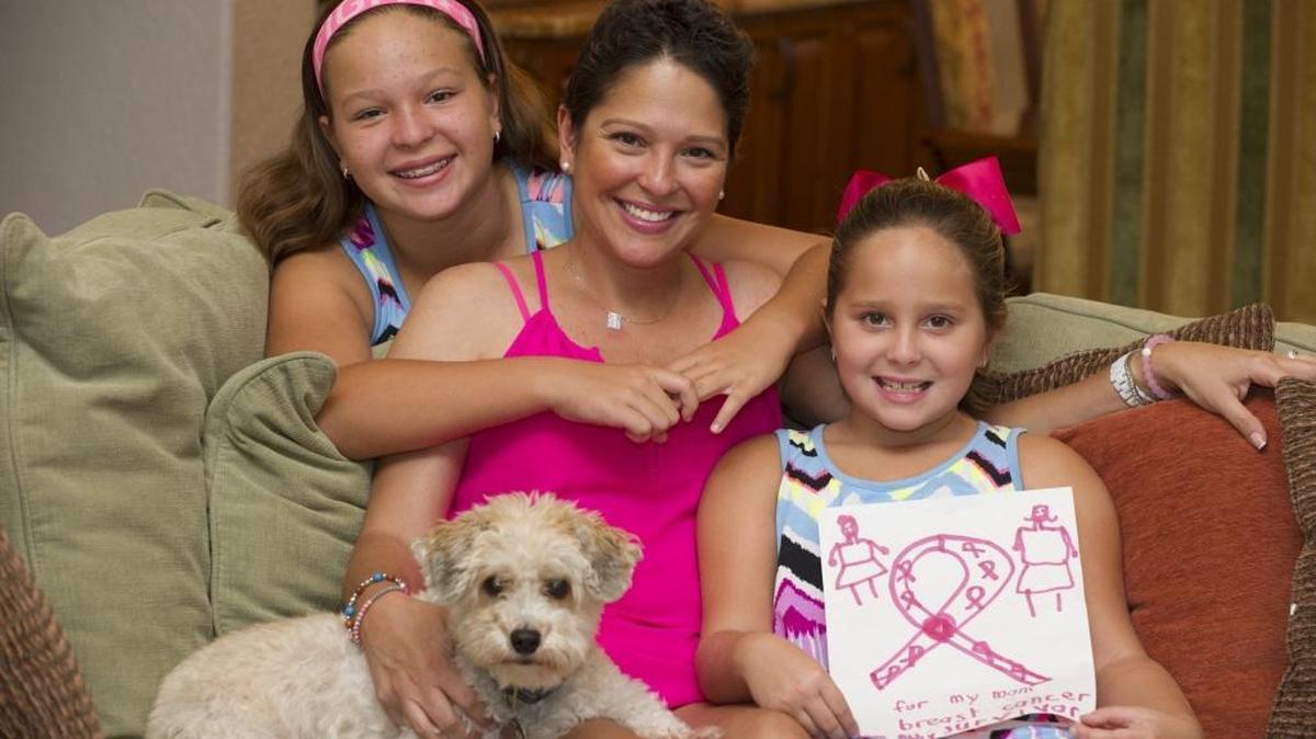Gracy Ordoñez, a breast-cancer survivor, and her daughters Emma, 11, left, and Abby, 7, in their home in Davie.