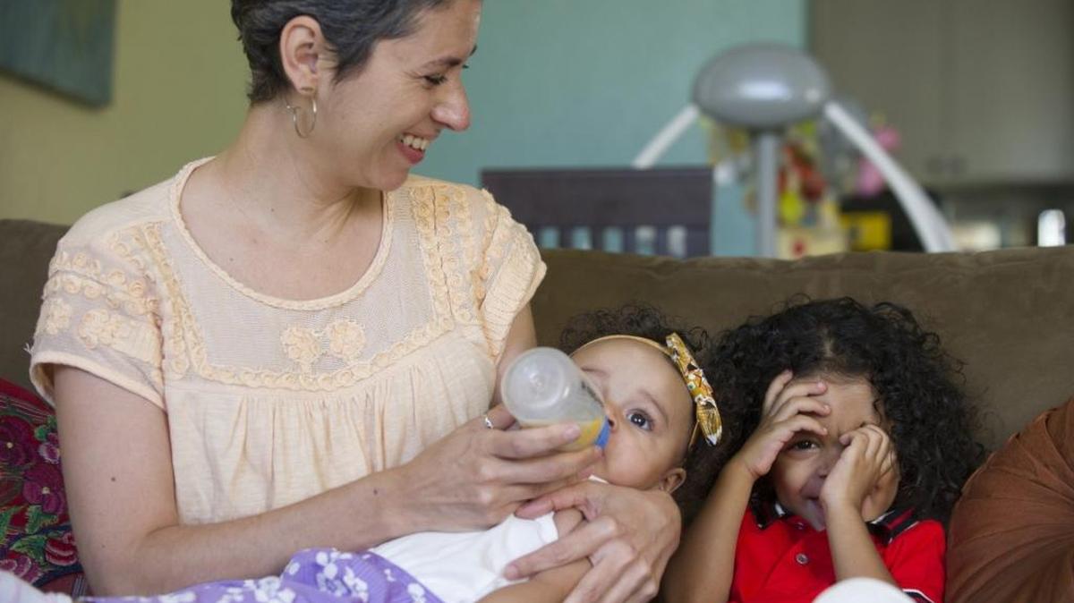 Juliette Graziano, a breast-cancer survivor, enjoys her 7-month-old daughter Janiya and son Jakari, 2, at their home in Miami Beach. Graziano was diagnosed with breast cancer when she was pregnant.