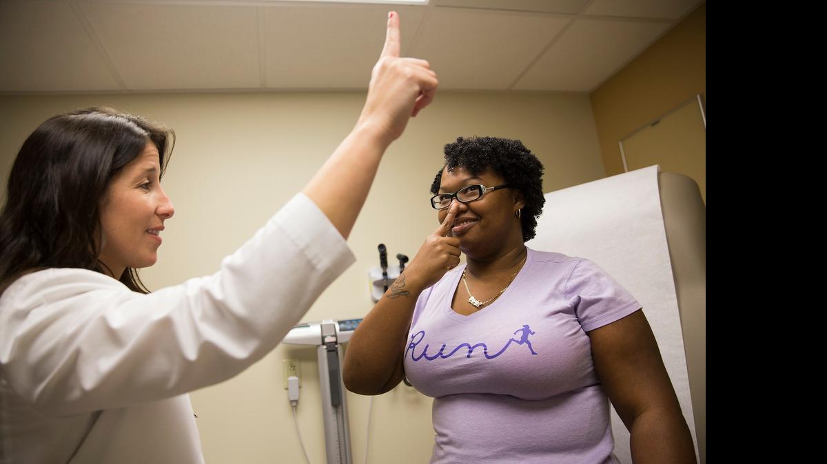 
Dr. Patricia Feito performs a neurologic exam on Crystal Harris at Baptist Health Primary Care in Miami. Harris used to suffer from multiple, severe migraines each month. Harris adopted a new diet and exercise routine recommended by Feito and said she now experiences migraines only once per month.
