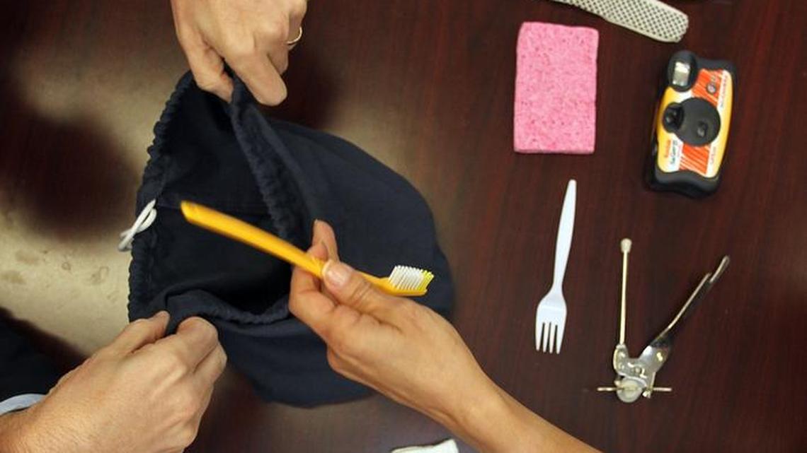 Dr. David A. Loewenstein, left, professor of psychiatry with the University of Miami Miller School of Medicine, simulates a Semantic Interference Test, SIT, with a clinical psychiatrist at the medical school, as she identifies different objects in a bag and then has to recall them. The test helps diagnose those showing with moderate cognitive impairment.