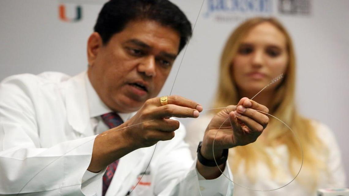 
Dileep R. Yavagal, M.D., Chief of UHealth Interventional Neurology, demonstrates how using a stent retrieval device, called Solitaire, he was able to grab a clot inside Isabel Vinueza’s blocked carotid artery. The device fastened itself to the clot and pulled the entire obstruction back into the catheter and out her leg. Vinueza said that she woke up from the surgery able to talk, move her hands and wiggle her toes and has had a remarkable recovery.

